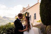 Sweet photo of newlyweds looking at each other with a villa in the background during their elopement in Italy