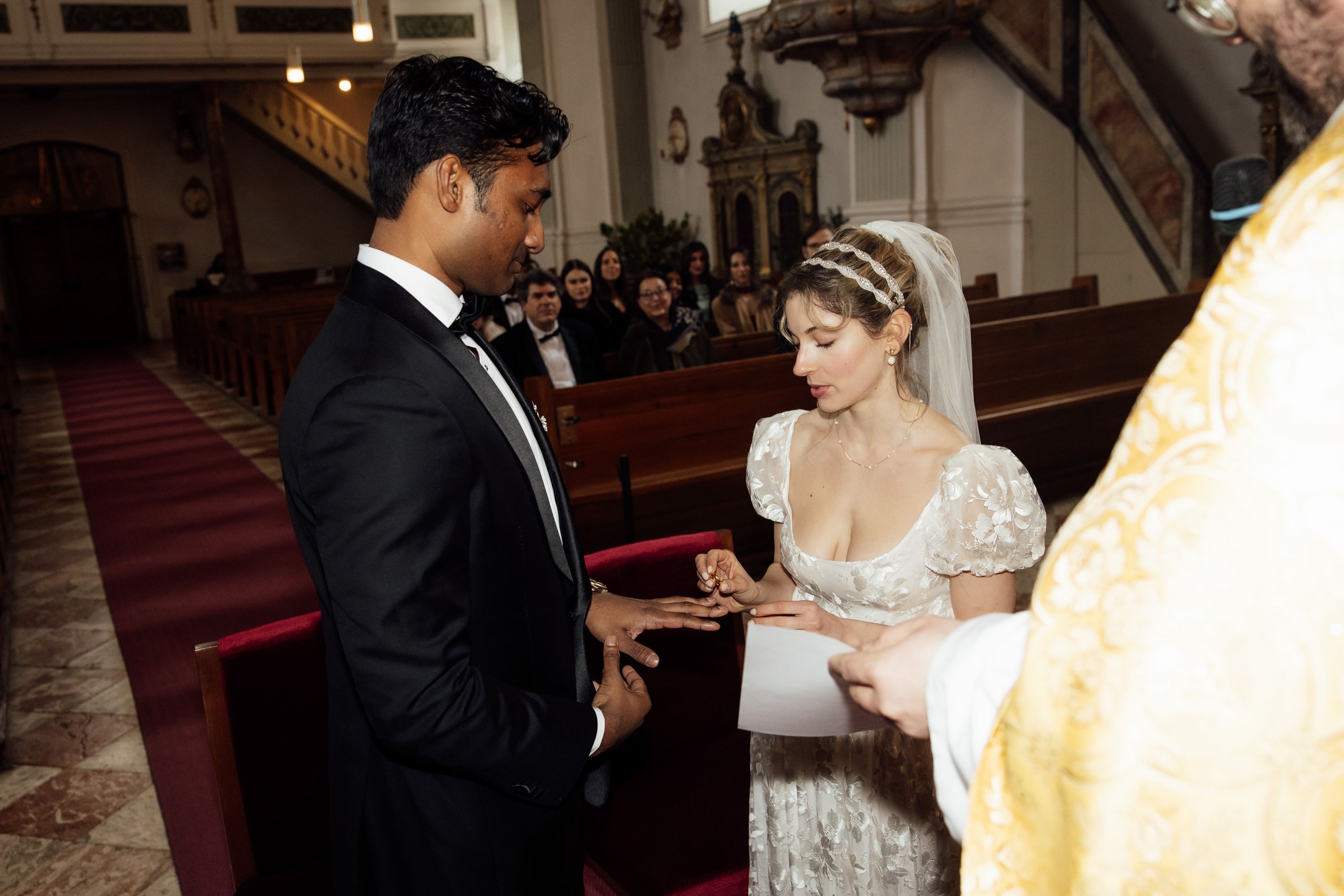 Couple exchanges wedding rings during an intimate wedding in Austria church ceremony