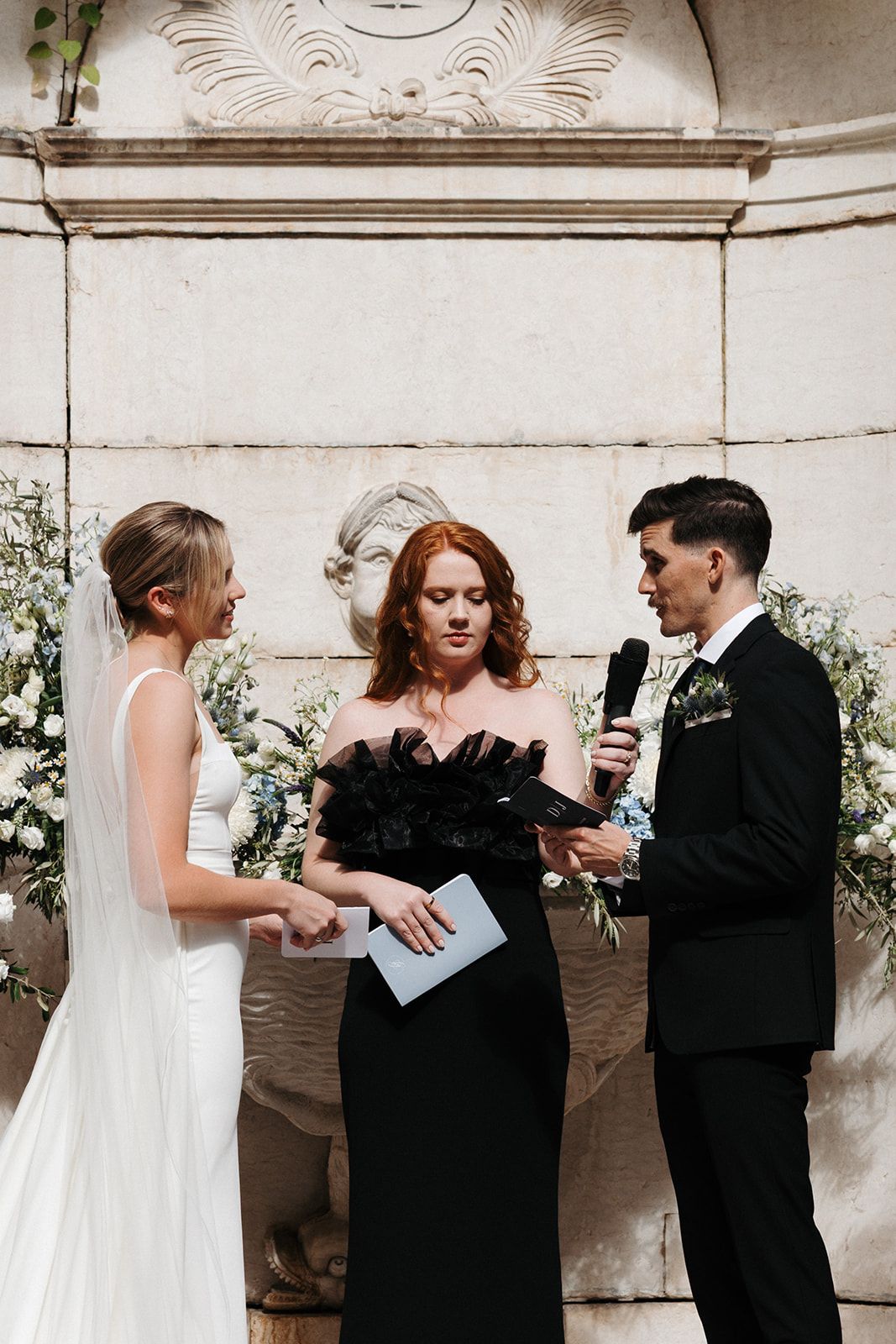 Groom reciting his vows in front of his groom and their celebrant during their destination wedding in Portugal