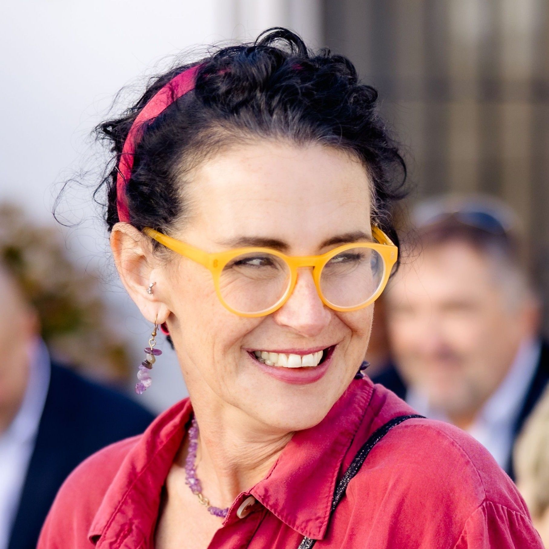 Our wedding planner in Spain smiling in the middle of guests during a wedding in Spain that she planned and coordinated