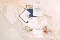 Flatlay of watercolor wedding invitation for a French chateau wedding