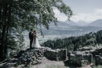 A couple with mountain and alpine forest backdrop at an elopement in Austria.