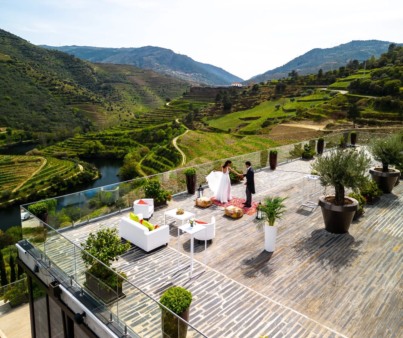 Newlyweds on top of a terrace with vineyard and lake views for destination weddings in Portugal